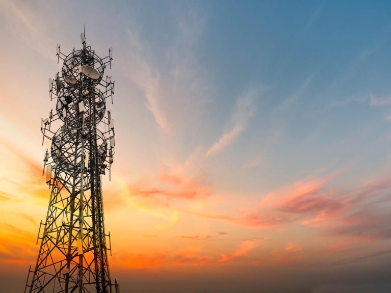 5G Sunset Cell Tower Cellular communications tower for mobile phone and video data transmission