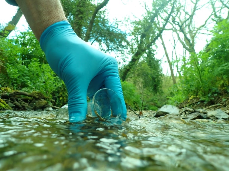 collecting a water sample from a stream