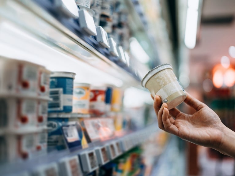 Consumer Protection image, customer holding a product in a grocery store