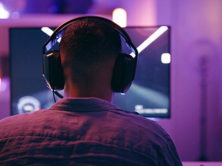 Person with headphones in front of computer