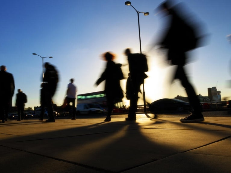 People on the street at dusk