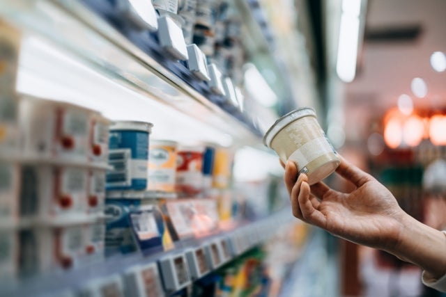 Consumer Protection image, customer holding a product in a grocery store