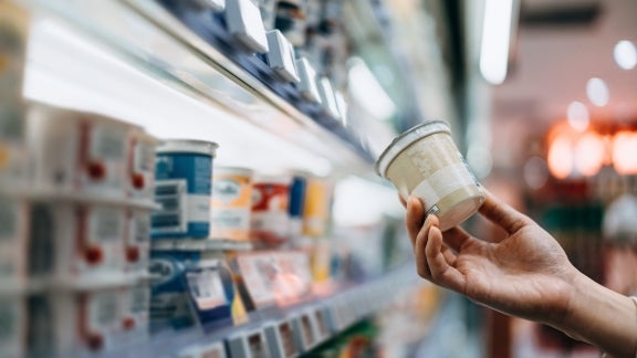 Consumer Protection image, customer holding a product in a grocery store