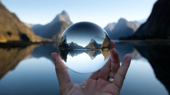 Hand holding glass ball