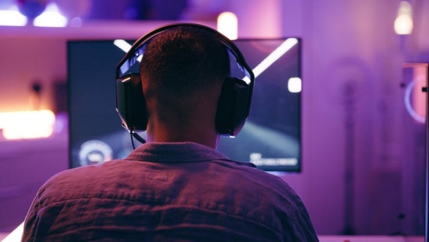 Person with headphones in front of computer